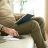 Cropped image of aged man checking his bills and credit payments